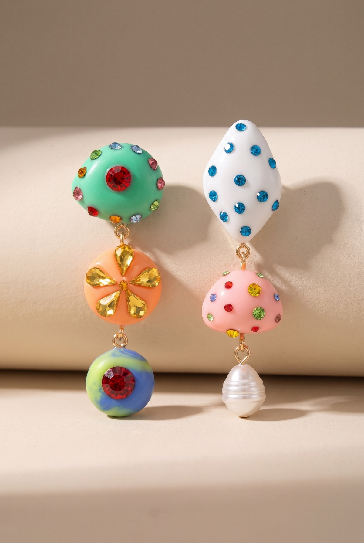 Wiola colored rhinestone drop earrings on a warm cream surface